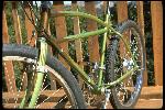 Wende Cragg’s chestnut on brown Schwinn “Excelsior-type” bike. This bike represents the state of the art at the time. Paint job is by Alan Bonds. Show partial bike view from front, non-drive side