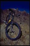 In early 1979 Gary Fisher asked Tom Ritchey to build him a balloon tire frame. Tom built three, one for Fisher, one for himself, and one to sell. The bike pictured, Gary Fisher’s, is one of the first three Ritchey mountain bikes.Front view with wheel cocked, on rocks, Castle Peak in background at Crested Butte. 