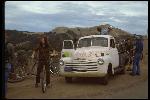 Unloading Frank Chappell’s 1954 Chevrolet 1/2 ton pick up truck across from Meadow Club. Rode to Azalea Hill from here, and then on dirt to Repack. Left to right,  Eric Bredt , astride bike, Joe Breeze, unident., Kent Bostick, holding Breezer  number 1, and Chris Lang. 